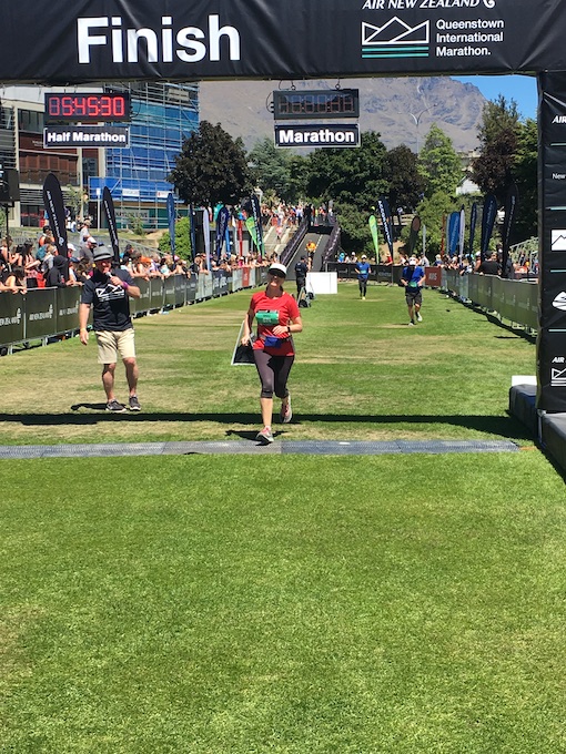 Sharon Schindler running across the Queenstown Marathon finish line.