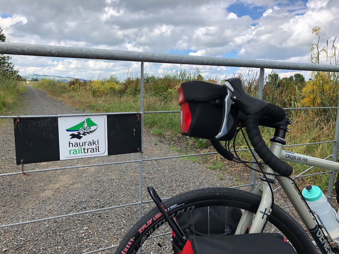 Hauraki Rail Trail New Zealand Bicycle parked next to a gate on the Hauraki Rail Trail