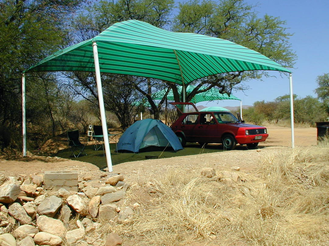 Campsite in Namibia Campsite in Namibia with the tent and car underneath a sun shade